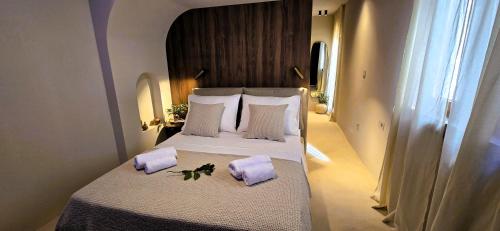 a bedroom with a large bed with purple pillows at C a s a B e a s t in Split