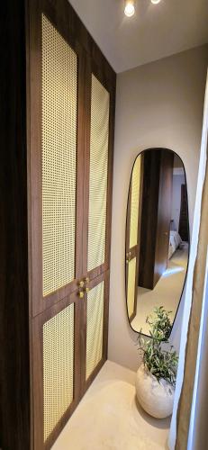 a room with a door and a mirror and a plant at C a s a B e a s t in Split