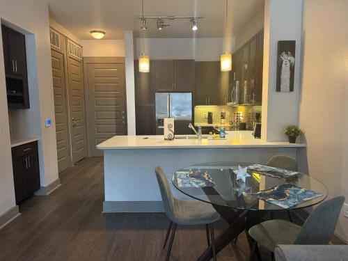 a kitchen with a glass table and a counter at Downtown Houston Retreat with Free Parking in Houston