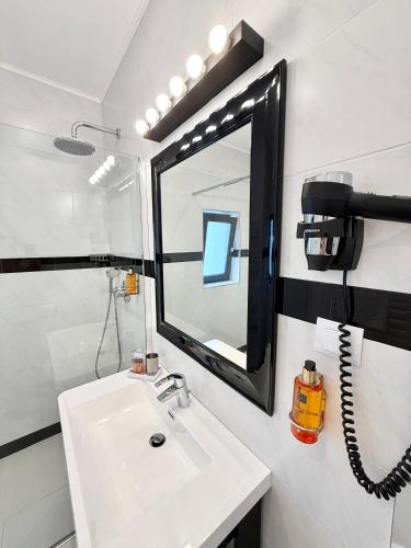 a bathroom with a sink and a mirror at Krystal Boutique Mansion in Hunedoara