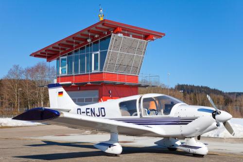 a small airplane parked in front of a building at Ferienhaus Alpenpanorama Chalet in Mollenberg