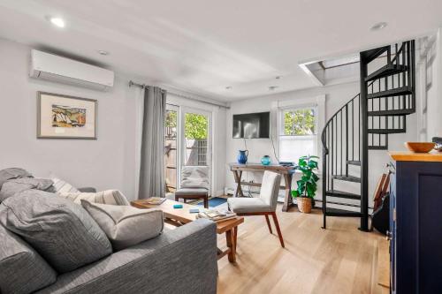 a living room with a couch and a table at Charming Getaway 1 Block from Beach in Provincetown