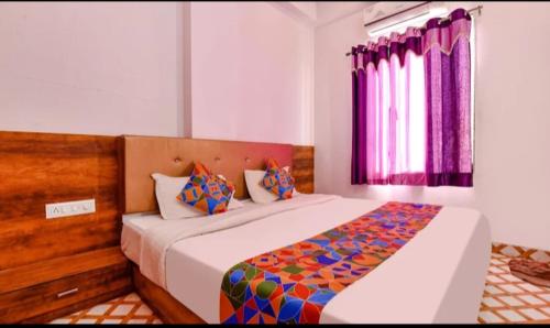 a bedroom with a large bed in a room at Shree aurora residency 900 metres from railway station and bus depo in Udaipur