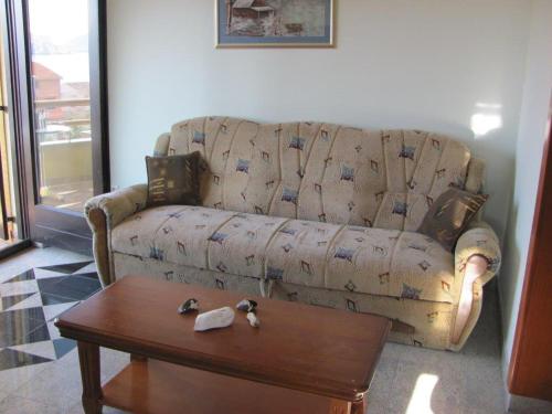 a living room with a couch and a coffee table at Soleil Apartmanok Baska in Baška