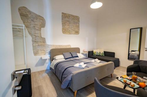 a bedroom with a bed and a living room at B&B Belvedere All'Idria in Ragusa