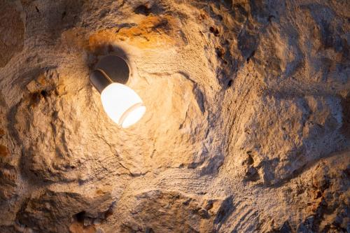 a light bulb in the middle of a rock formation at Apartment with Sea view B in Tsoukaladhes