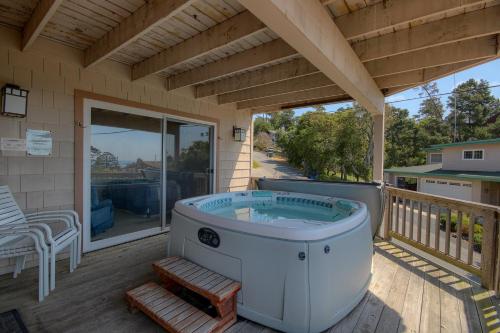 a hot tub on the deck of a house at Dream Catcher in Cambria