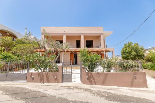 a house with a gate in front of it at Lyria Hotel Apartments in Stalos