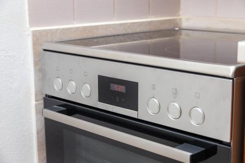 a stove top oven sitting in a kitchen at Lyria Hotel Apartments in Stalos