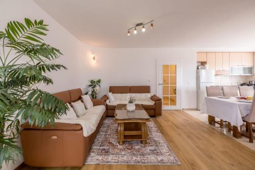 a living room with a couch and a table at Apartments Nada in Trogir