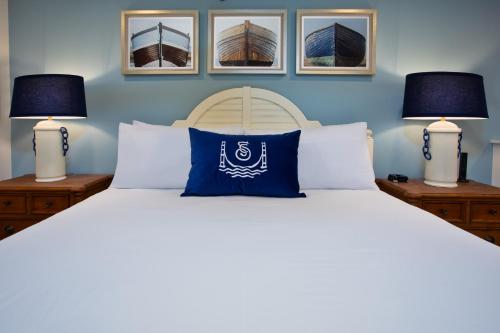 a bedroom with a large bed with two lamps at The Inn at Stonecliffe in Mackinac Island