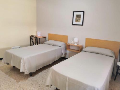Posteľ alebo postele v izbe v ubytovaní Hostal Torre Mar