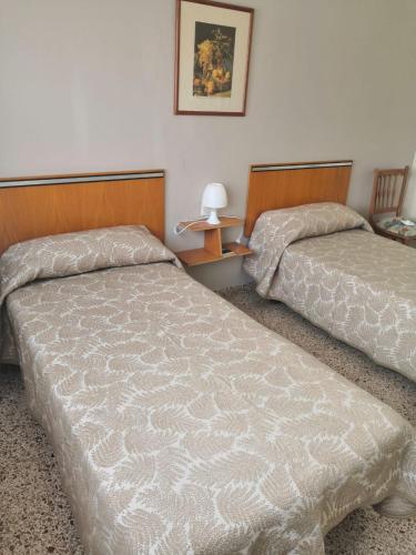 Ένα ή περισσότερα κρεβάτια σε δωμάτιο στο Hostal Torre Mar
