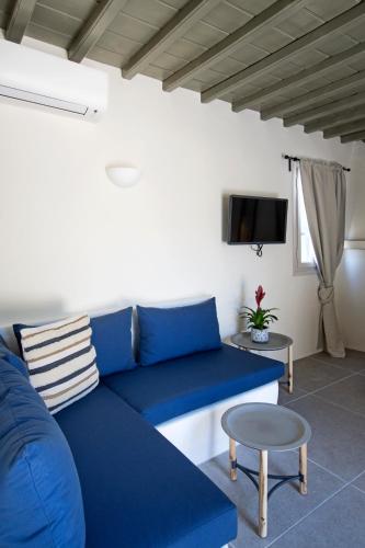a blue couch in a living room with a tv at Mykonos home Delphini in Mýkonos City