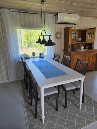 a dining room table with chairs and a blue table cloth at Sjöstugan in Hudiksvall