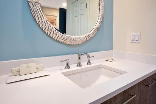 a bathroom with a white sink and a mirror at The Inn at Stonecliffe in Mackinac Island