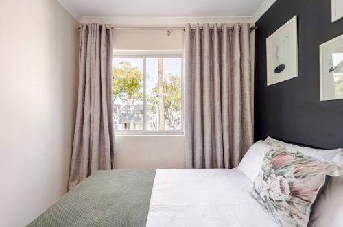 a bedroom with a bed and a window at Cozy loft with swimming pool in Johannesburg