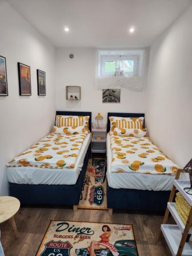 a bedroom with two beds and a table at Retro House ogród prywatny parking x 2 i stacja ładowania parter in Przemyśl