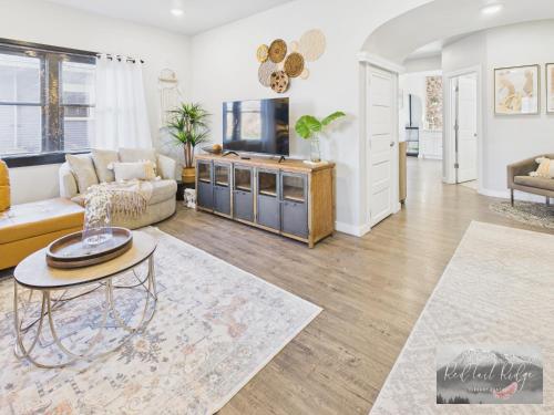 a living room with a couch and a tv at Boho Revival Modern Glam with AC in Downtown Albany in Albany