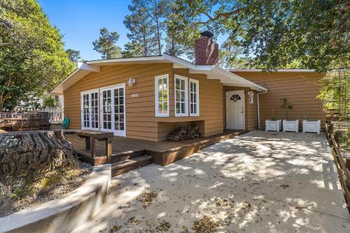 a small yellow house with a porch and a picnic table at Home Sweet Home New Monthly in Cambria