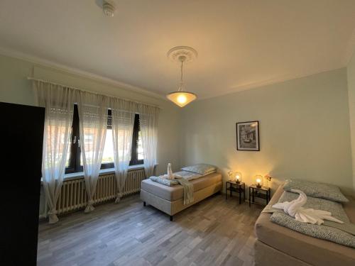 a living room with two beds and a couch at Cozy Private Rooms in Wesseling in Wesseling