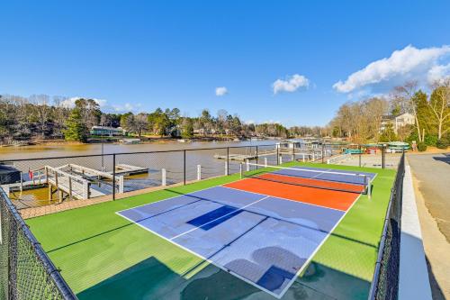 an image of a tennis court next to a river at Lake-View Home with Pool Access in Sherrills Ford! in Sherrills Ford