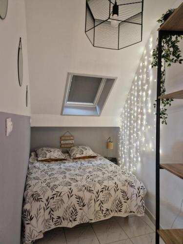 a bedroom with a bed with lights on the wall at Appartement 37 m2 avec balcon in Berck-sur-Mer