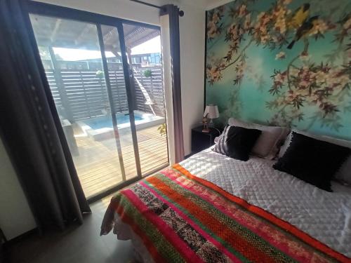 a bedroom with a bed with a view of a balcony at SirenaHouse, Casa a metros del Mar in De Cauquenes