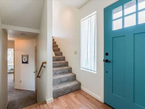 a staircase with a blue door in a house at Casa De Marina in Cambria