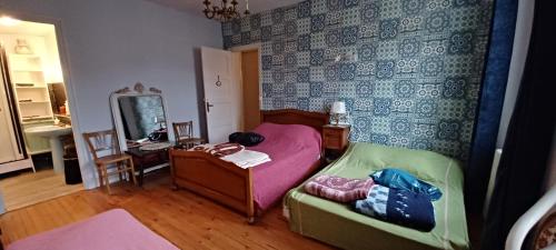 a small bedroom with a bed and a mirror at Chez Virginie - chambre du Bourg in Lourdes