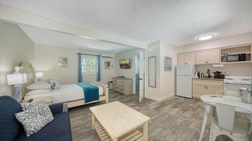 a living room with a bed and a kitchen at Siesta Key Palms Resort in Sarasota