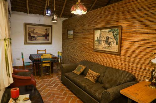 a living room with a couch and a table at Cabañas Mannan in Tanchachín