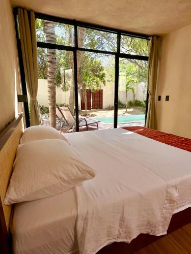a bedroom with a large bed and a large window at Casa Yag in Brisas de Zicatela