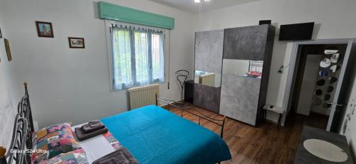 a living room with a blue bed and a window at Ferrara1 in Ferrara