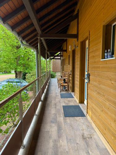 a covered porch of a house with tables and chairs at Ma Campagne in Saint-Rémy