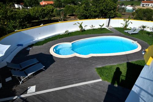 a swimming pool on a patio next to a house at Casa La Rosa with private pool in Loja de Vendas