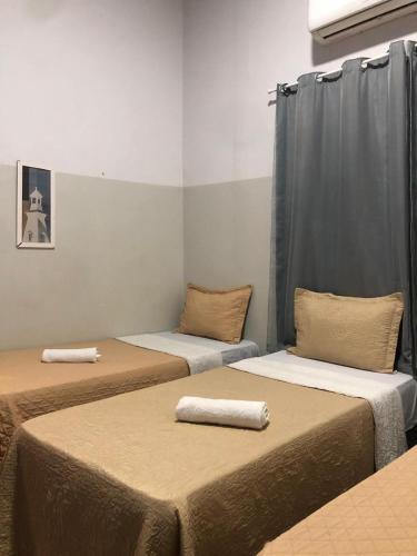 a room with three beds in a room at Ágape Hotel in Rio Verde