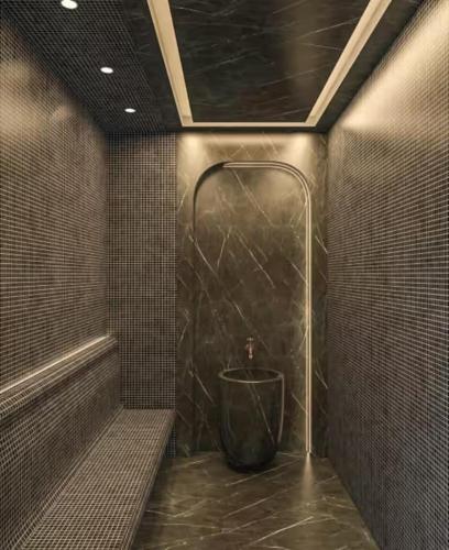 a tiled bathroom with a shower with a tub at Grand Sapphire Resort & Casino in Phikardhou