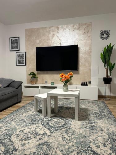 a living room with a table and a tv at Marina Spacious Family Apartment in Križišće