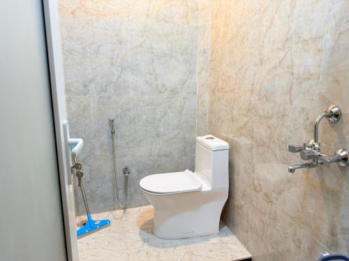 a bathroom with a toilet and a shower at Popli Paradise Resort in Jaipur