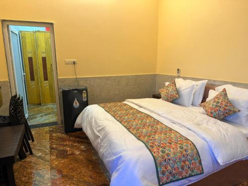 a bedroom with two beds and a door to a room at Popli Paradise Resort in Jaipur
