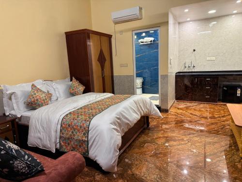 a hotel room with a bed and a fireplace at Popli Paradise Resort in Jaipur