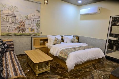 a hotel room with two beds and a table at Popli Paradise Resort in Jaipur