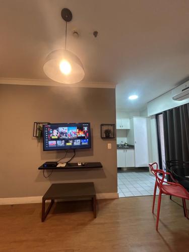 a living room with a flat screen tv on the wall at Hotel Aeroporto Congonhas com cozinha e sacada 1108 S in Sao Paulo