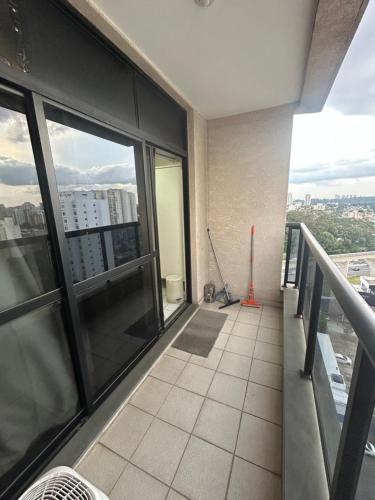 an apartment balcony with a view of a city at Hotel Aeroporto Congonhas com cozinha e sacada 1108 S in Sao Paulo