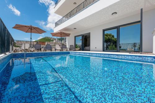 a swimming pool in a house with a house at Villa Marta in Makarska
