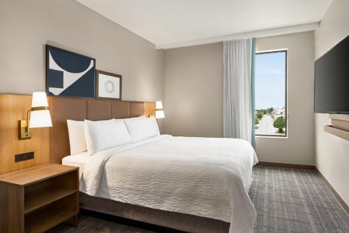 a hotel room with a bed and a window at Staybridge Suites Kincardine Southeast in Kincardine