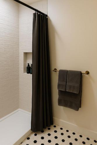 a bathroom with a shower with a shower curtain at Downtown Huntsville Gem in Muskoka in Huntsville