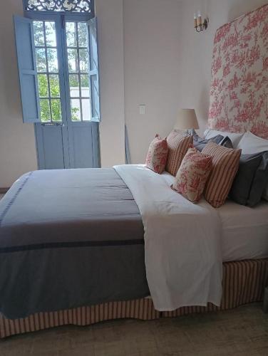 a large bed with pillows on it in a bedroom at Hotel MasClara in Villa de Leyva