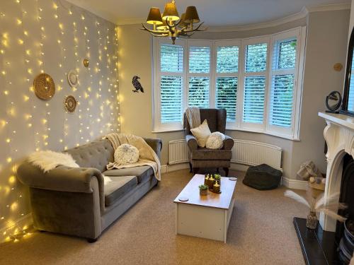 a living room with a couch and a fireplace at The Nordic Nook - 3 bedroom house plus double sofabed in York